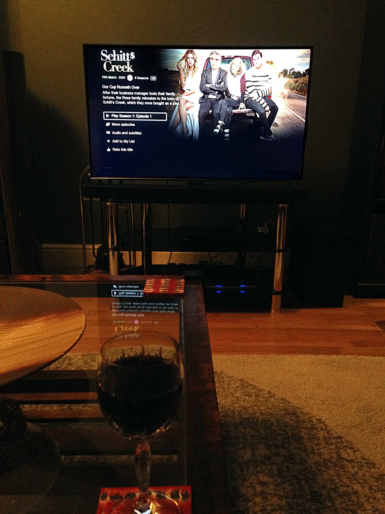 A TV showing the Netflix title card for Schitt’s Creek episode 1